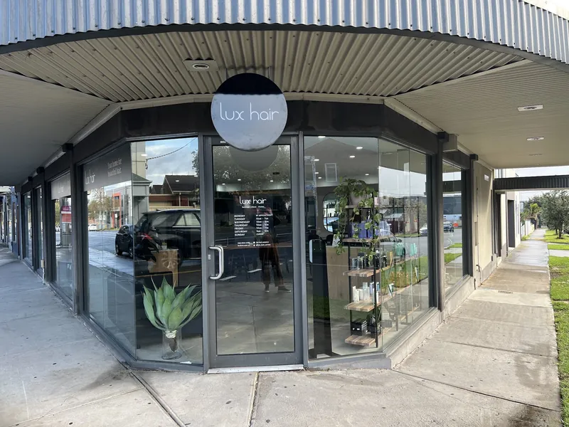 Lux Hair shopfront: charcoal facade, full glass corner and round lux hair sign on Plenty Rd